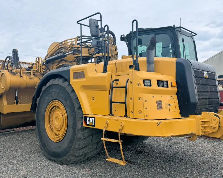 A spacious, well-kept yellow 2017 Cat 637K 2 Scraper positioned on a gravel lot.